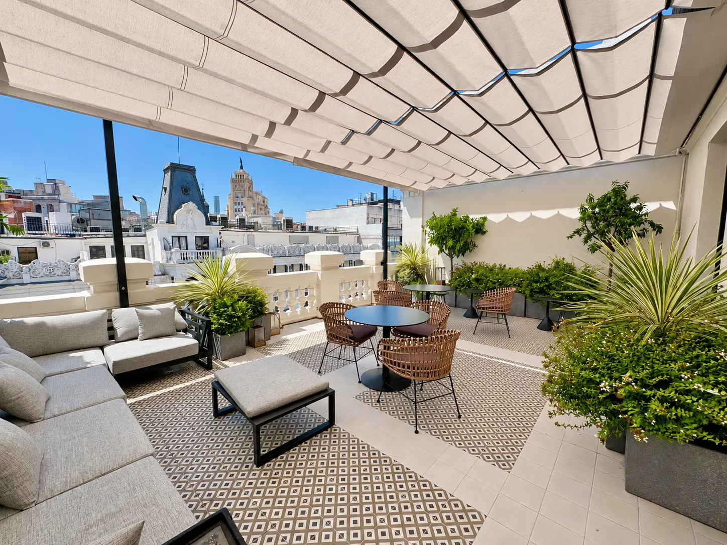 Terraza para eventos en Gran Vía, Madrid · toldo, sofás y mesas con vistas a los edificios de Gran Vía